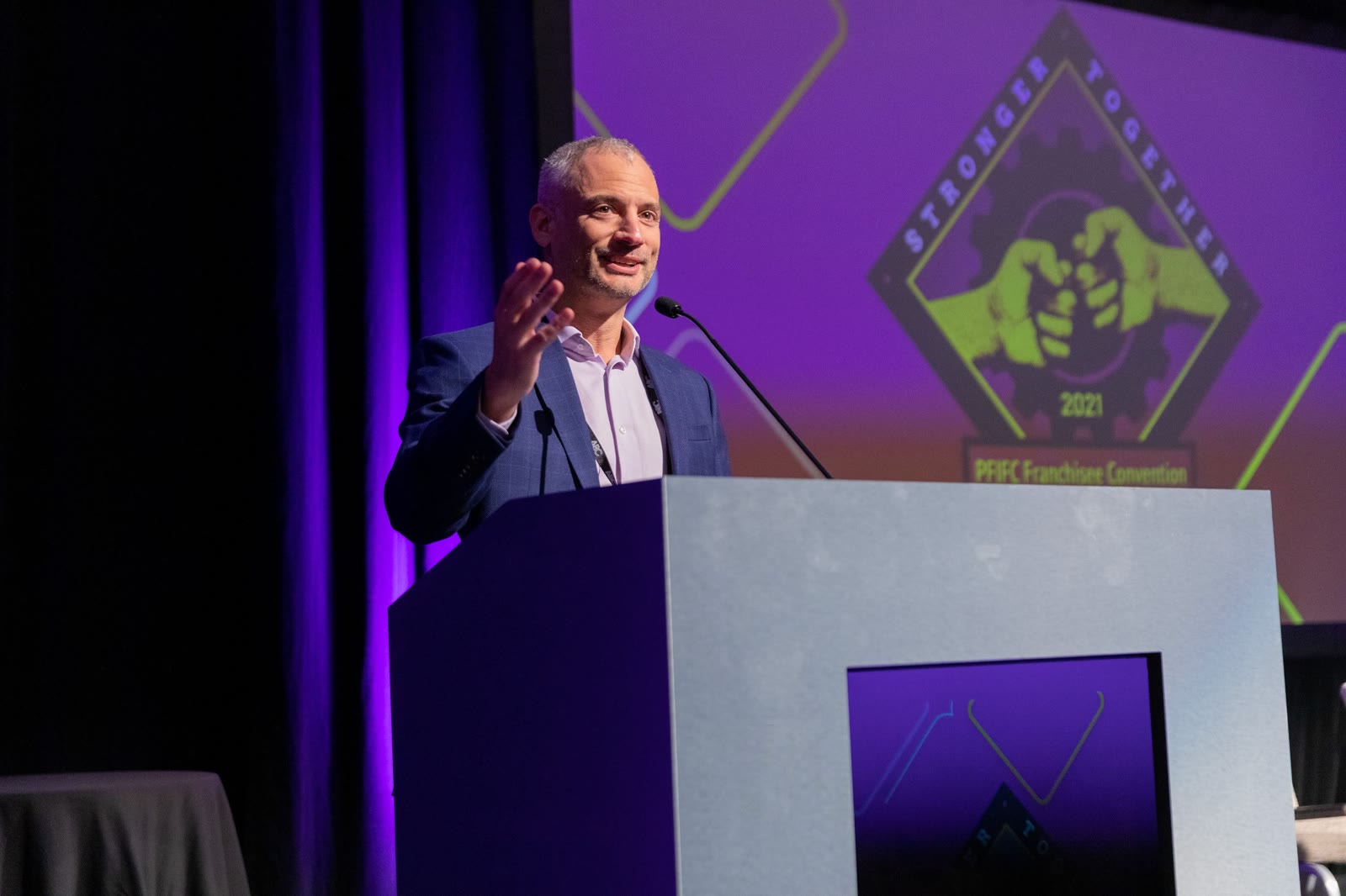 Jeff Helfgott speaking at a conference podium